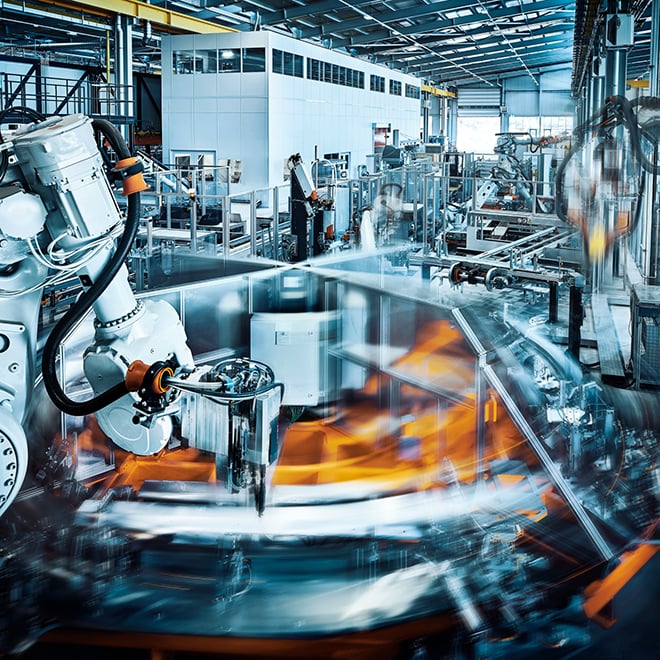 Industrial robotics in action, illustrating the shift from cloud-first to hybrid IT strategies that balance digital innovation with physical infrastructure.