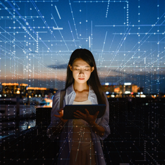Person interacting with AI-powered application on tablet, illustrating real-time edge AI processing in a connected environment
