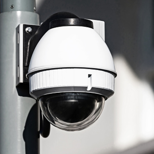 Photo of a 24/7 surveillance security camera outside of a data center. 